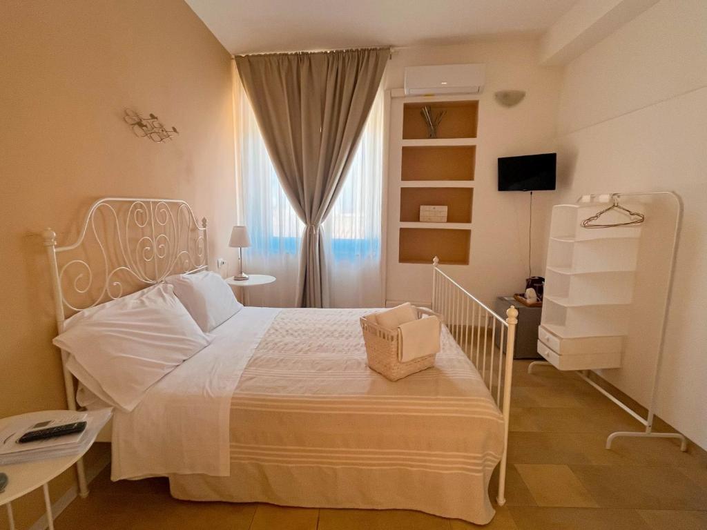 Postel nebo postele na pokoji v ubytování Regina Margherita B&B