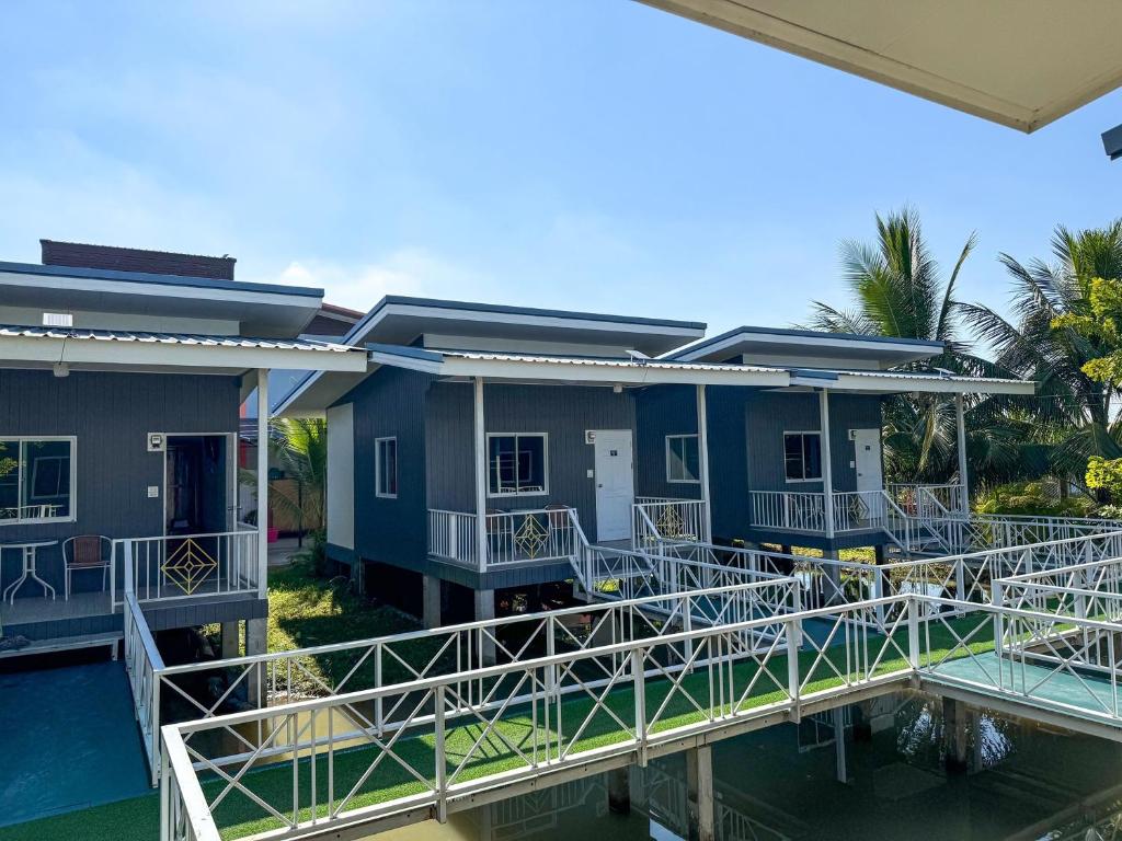a view of a house from the water at Jira Hotel in Lampang