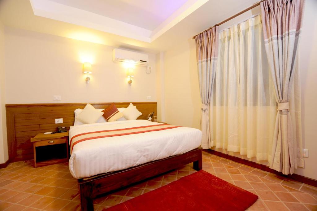 Postel nebo postele na pokoji v ubytování Hotel Utsab Himalaya