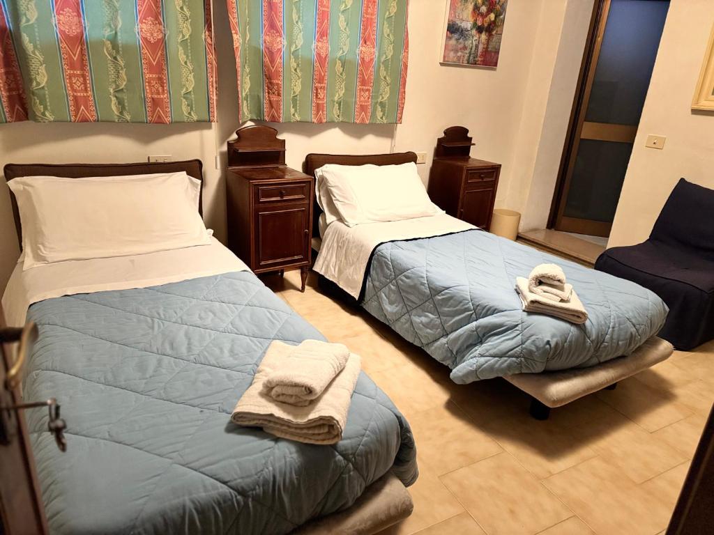 Postel nebo postele na pokoji v ubytování Hotel Le Logge