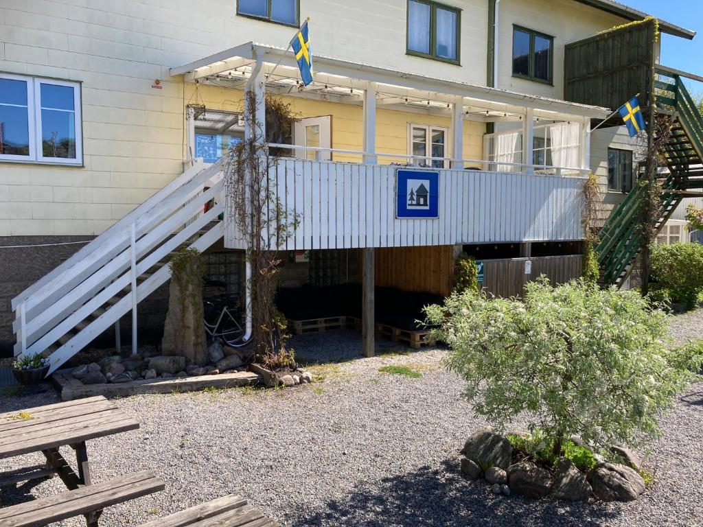 a house with a white staircase in front of it at Kustnära Vandrarhem in Hamburgsund