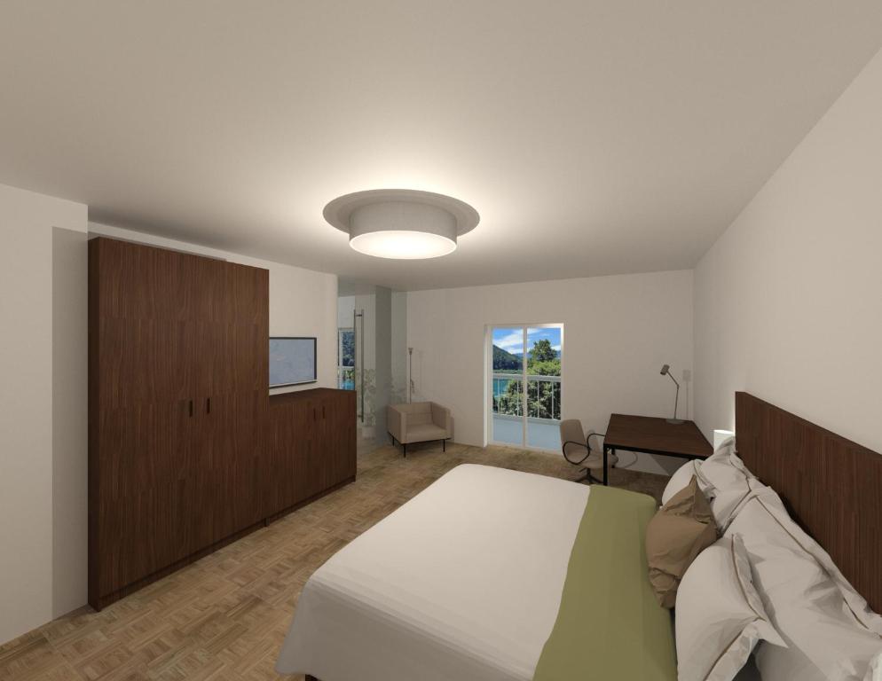 Postel nebo postele na pokoji v ubytování Aparthotel Klopeinersee