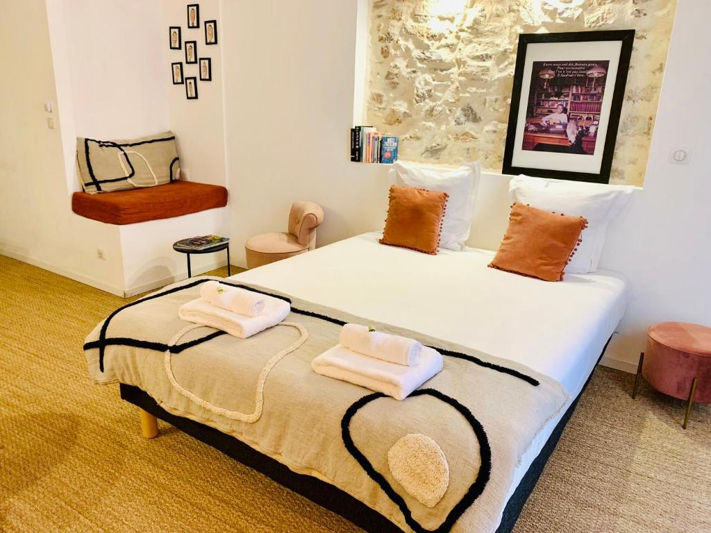 une chambre avec un grand lit avec deux serviettes dessus dans l'établissement Coquet studio en coeur de ville avec wifi et clim, à Sète