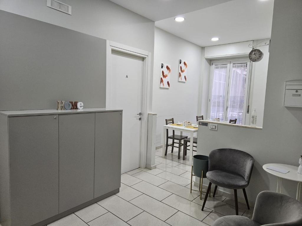 a kitchen with a counter and chairs and a table at binario&tre in Eboli