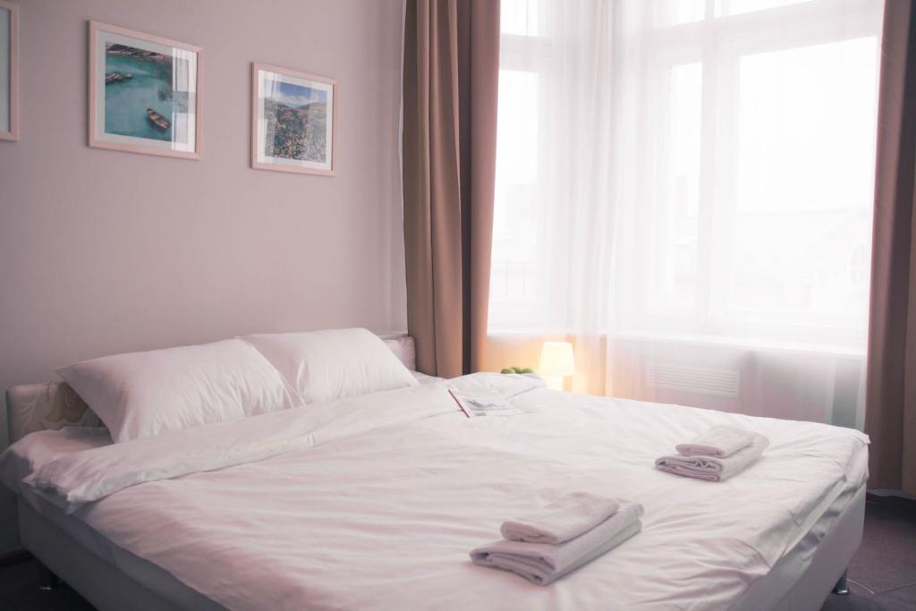 a bedroom with a bed with two towels on it at Ars Hotel on Krasnie Vorota in Moscow