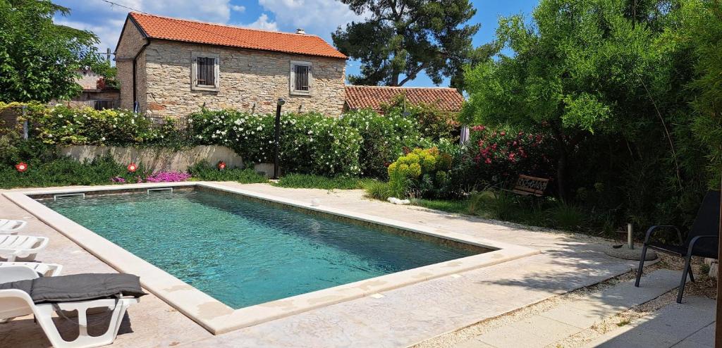 a swimming pool in front of a house at 1 Eti And Mia House in Muntić