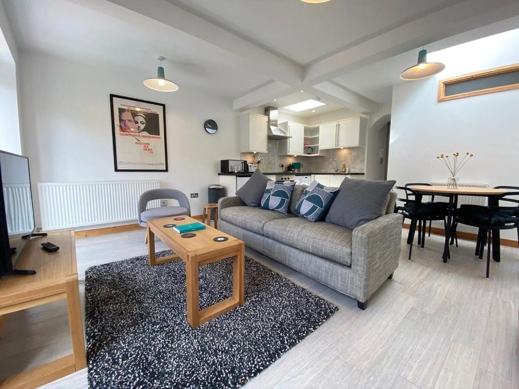 a living room with a couch and a table at St Benedicts Street Flat with Roof Terrace in Norwich