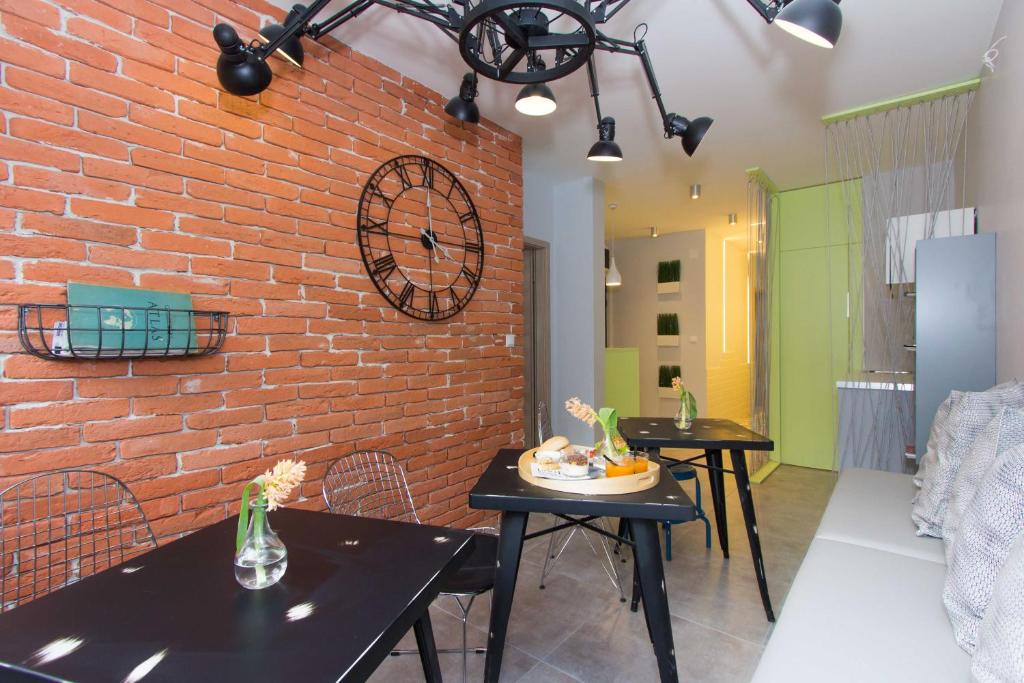 a room with two tables and a brick wall at B&B Vibe in Split