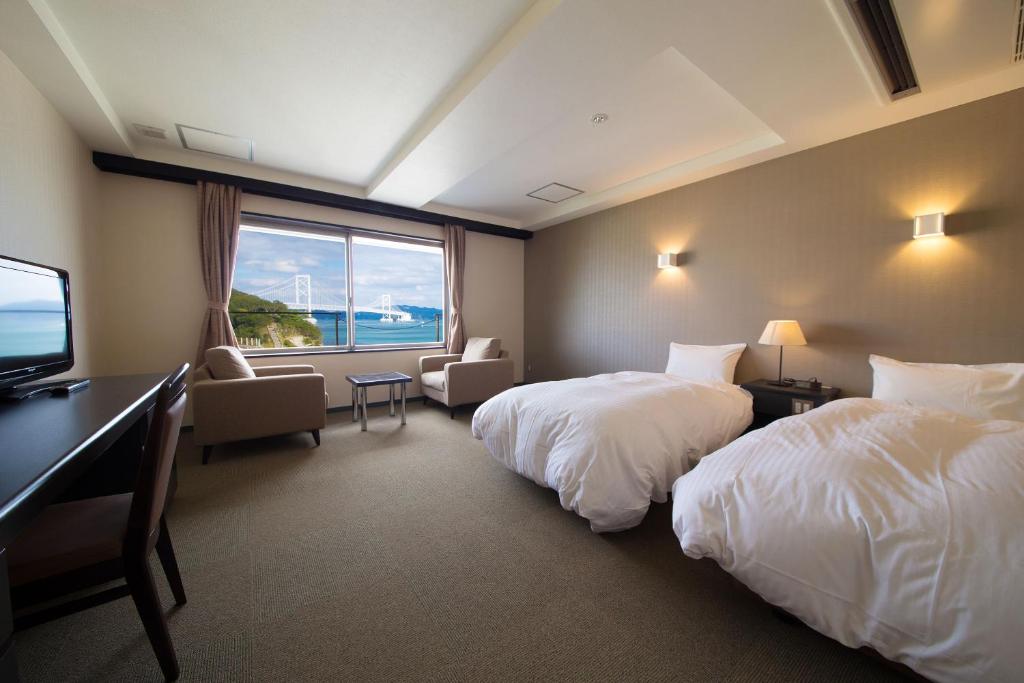 Postel nebo postele na pokoji v ubytování Seaside Hotel Taimaru Kaigetsu
