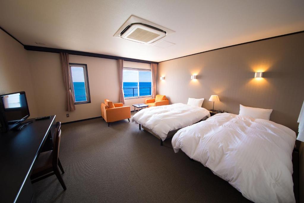 Postel nebo postele na pokoji v ubytování Seaside Hotel Taimaru Kaigetsu