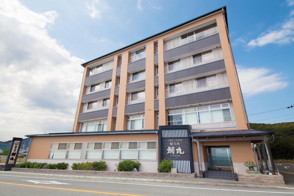 a tall building on the side of a street at Seaside Hotel Taimaru Kaigetsu in Naruto
