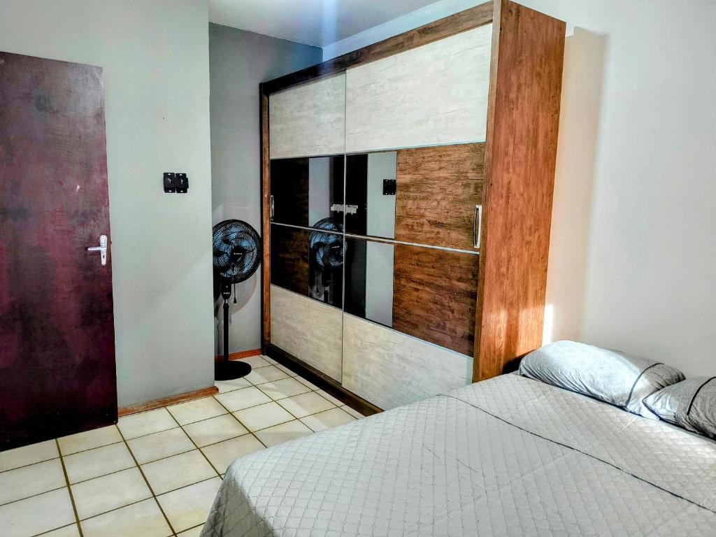 a bedroom with a large sliding door with two dogs in it at Pousada Recanto das Palmeiras in Florianópolis