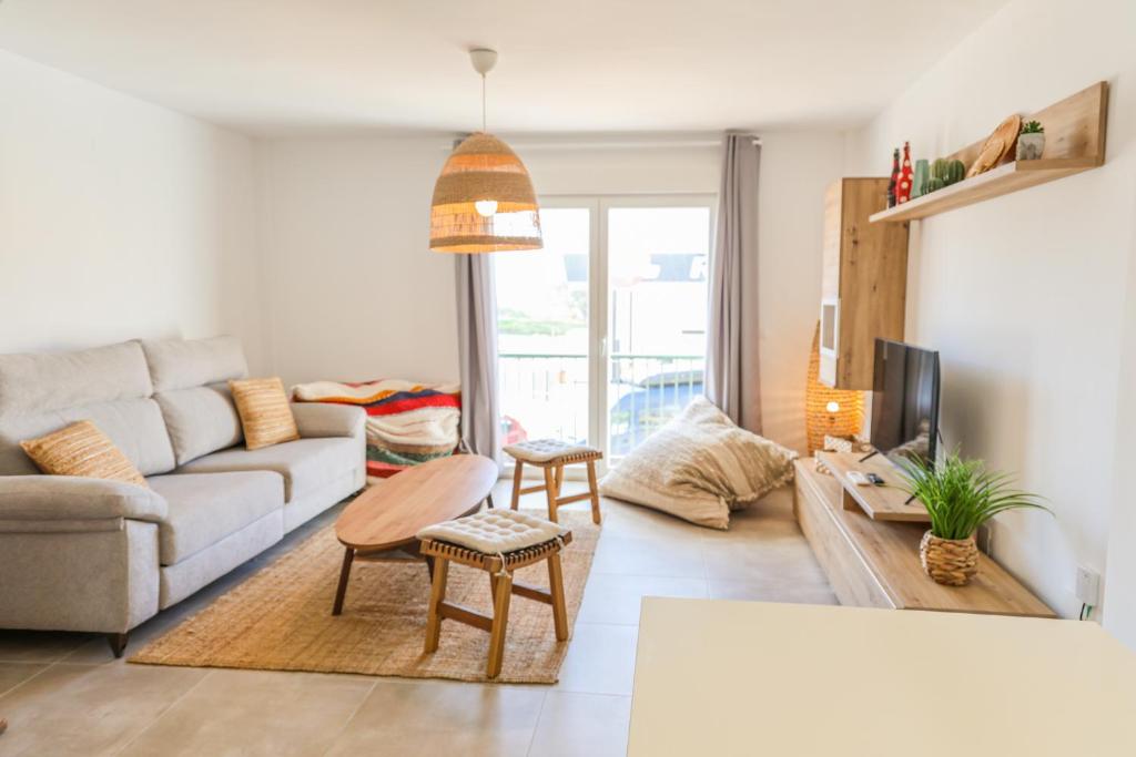 a living room with a couch and a table at Tarifa Cozy House - Casita Central in Tarifa