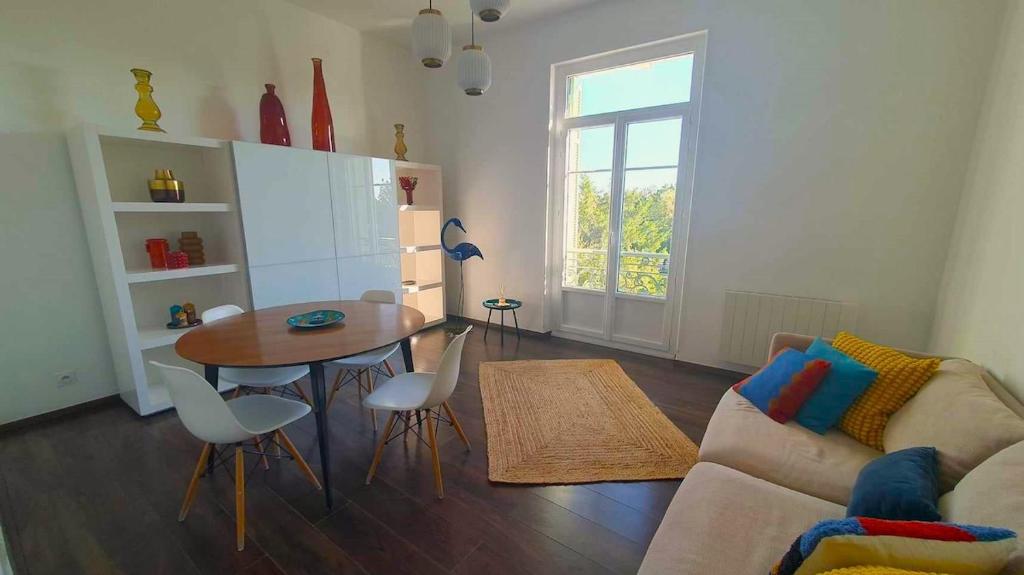 un salon avec une table et un canapé dans l'établissement Cozy apartment, à LʼIsle-sur-la-Sorgue
