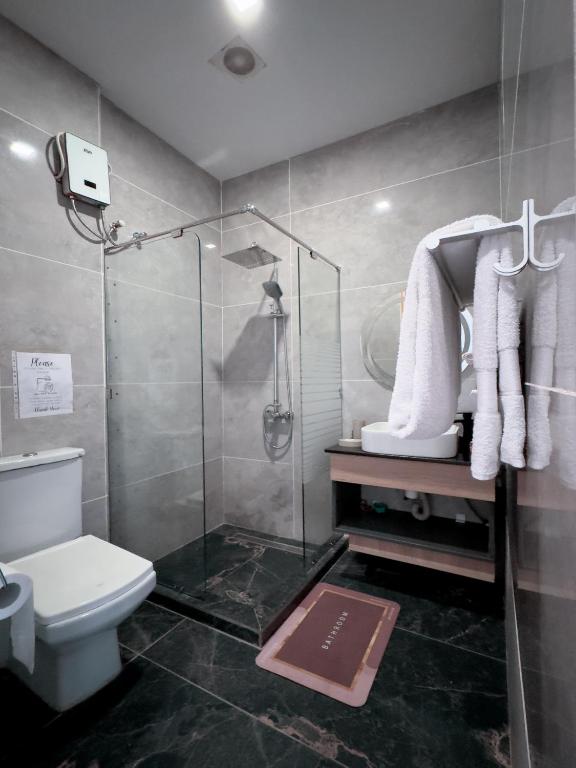 a bathroom with a shower and a toilet at Euro Homes Hotel in Accra