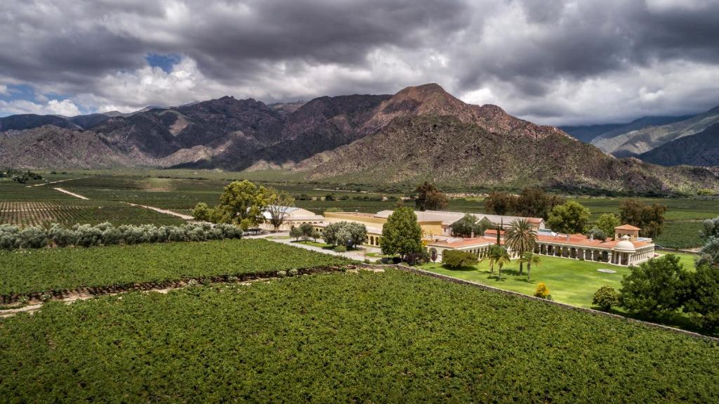 an aerial view of a farm with mountains in the background at Finca El Recreo in Cafayate