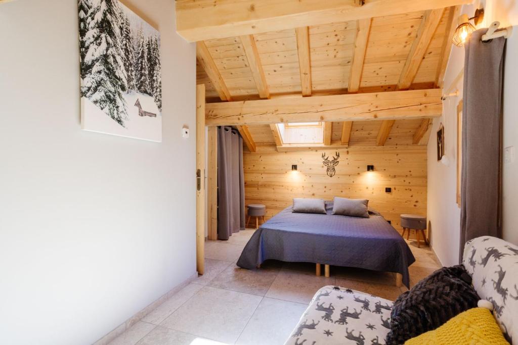 a bedroom with a bed in a wooden room at Meribel le chalet d'eugénie in Les Allues