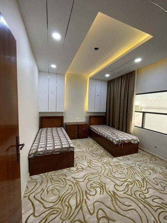 Postel nebo postele na pokoji v ubytování Bait AL-Afiah Apartments