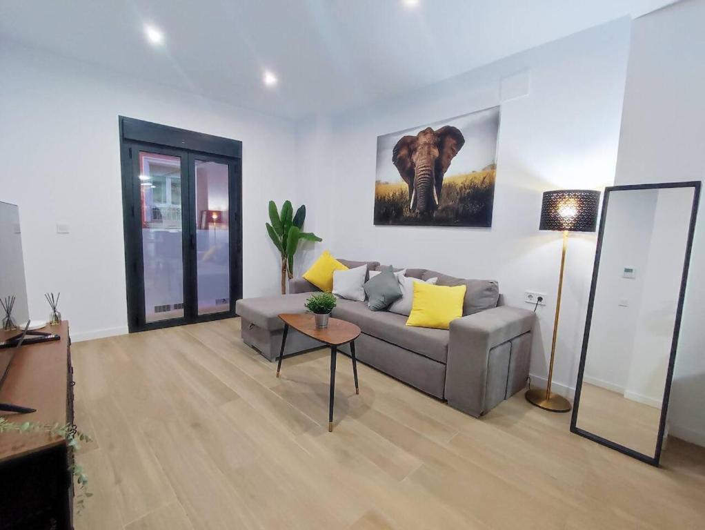 a living room with a couch and a table at Ohana home 2 in Málaga