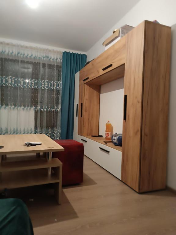 a room with a large wooden cabinet and a table at Casa Iriss in Calafat