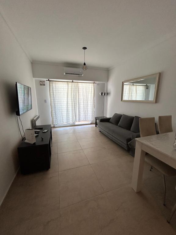 a living room with a couch and a table at Departamento a estrenar con pileta in Buenos Aires