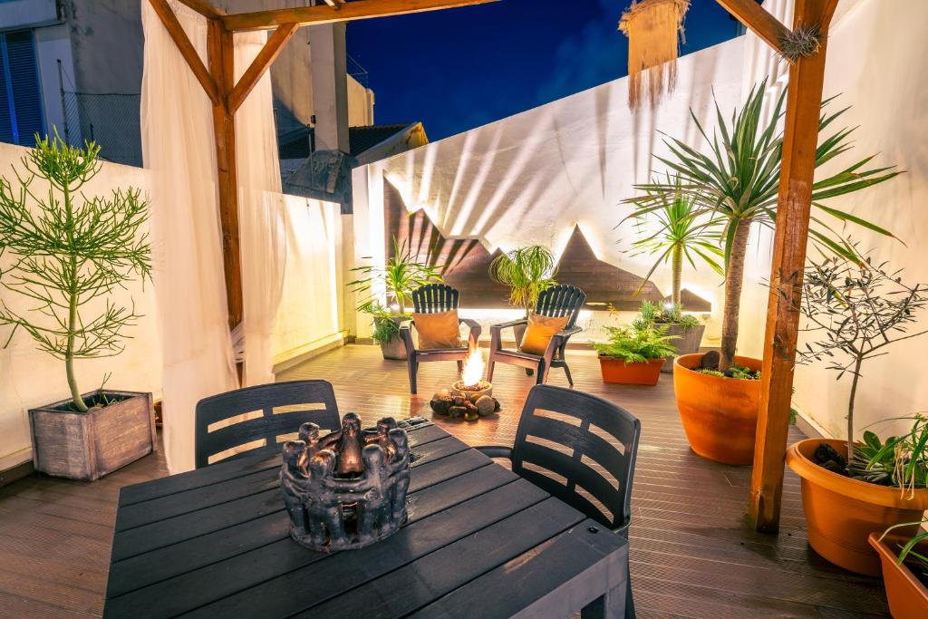 a table and chairs on a patio with plants at epicenter CITY in Ponta Delgada