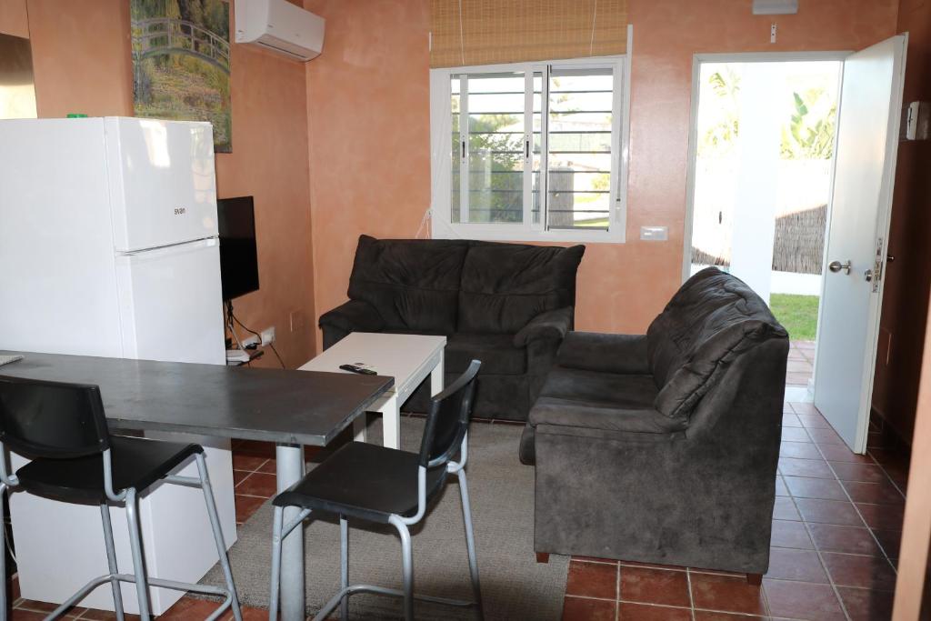 a living room with a couch and a table and chairs at DADA CAÑOS in Los Caños de Meca