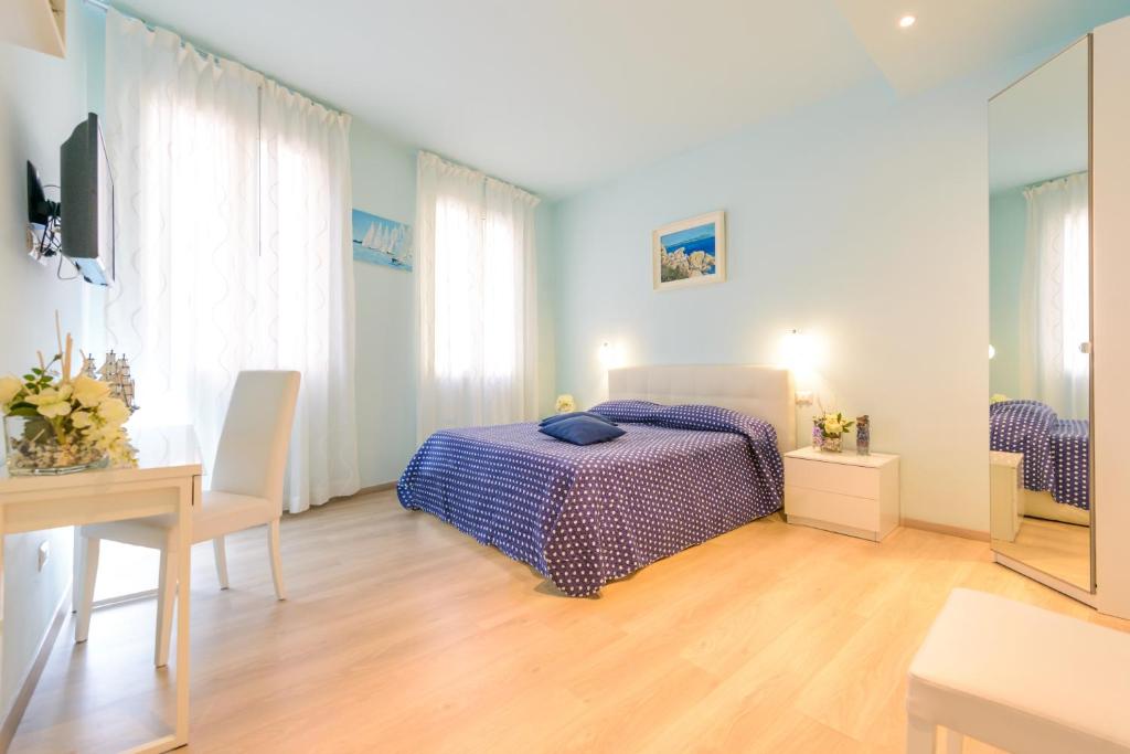 a bedroom with a bed and a table and a desk at Il Timone in Santa Margherita Ligure