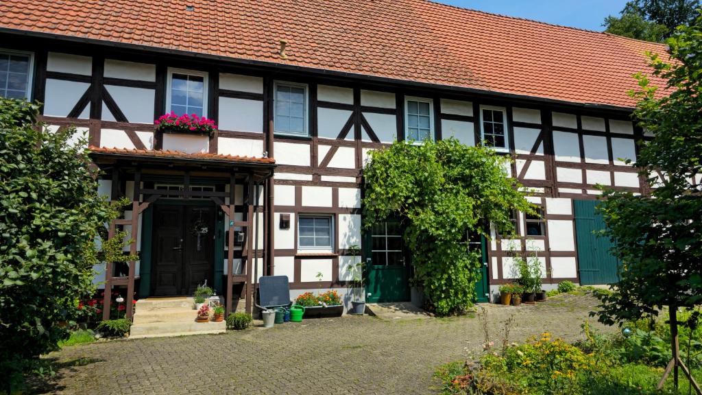 an old house with a red roof at Ferienwohnung Streckhofidylle in Osterode