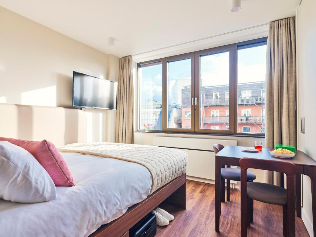 Postel nebo postele na pokoji v ubytování Numa The Hague Scheveningen