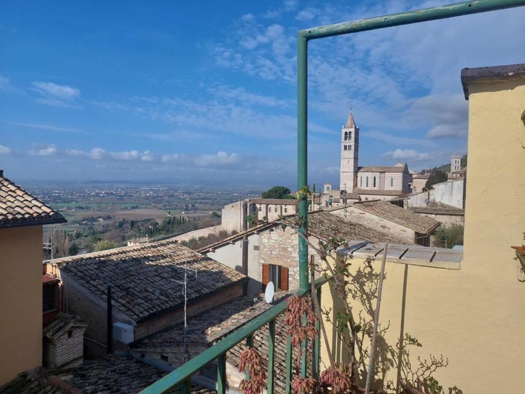 a view from the balcony of a building with a clock tower at Civico 5 in Assisi