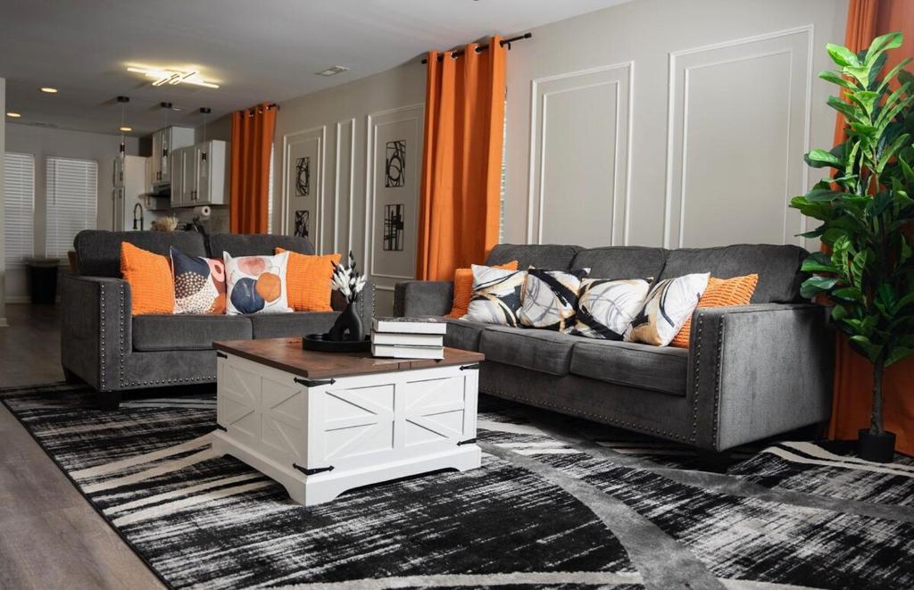 a living room with two couches and a coffee table at Raleigh With Daylor in Raleigh