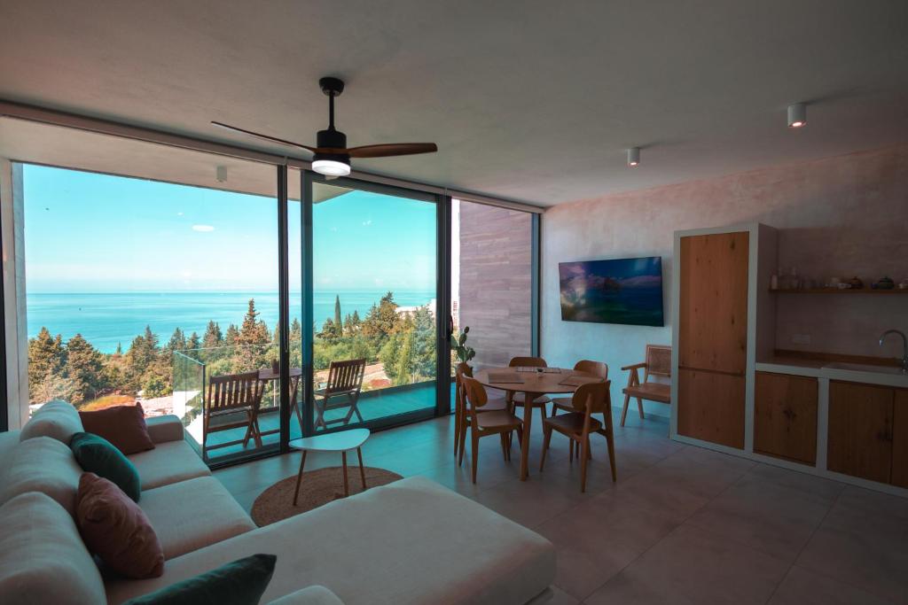 a living room with a couch and a table at Escape by Form Apartament 4 in Dhërmi