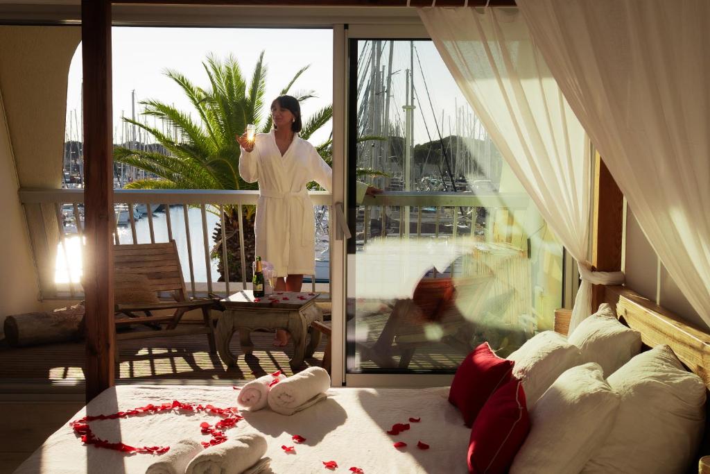 une femme debout sur un balcon parlant sur un téléphone portable dans l'établissement Amourette à Port Camargue, au Grau-du-Roi