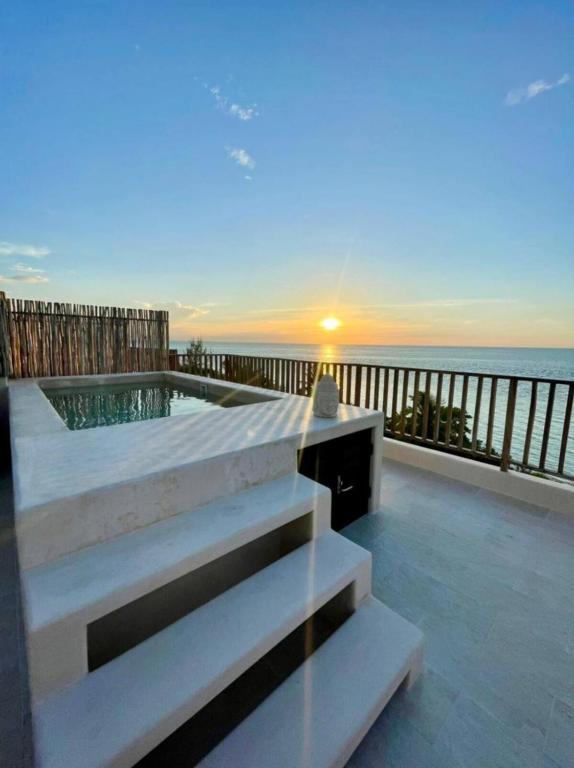 a balcony with a view of the ocean at Breathtaking Ocean Vista Penthouse with Private Pool in Holbox Island