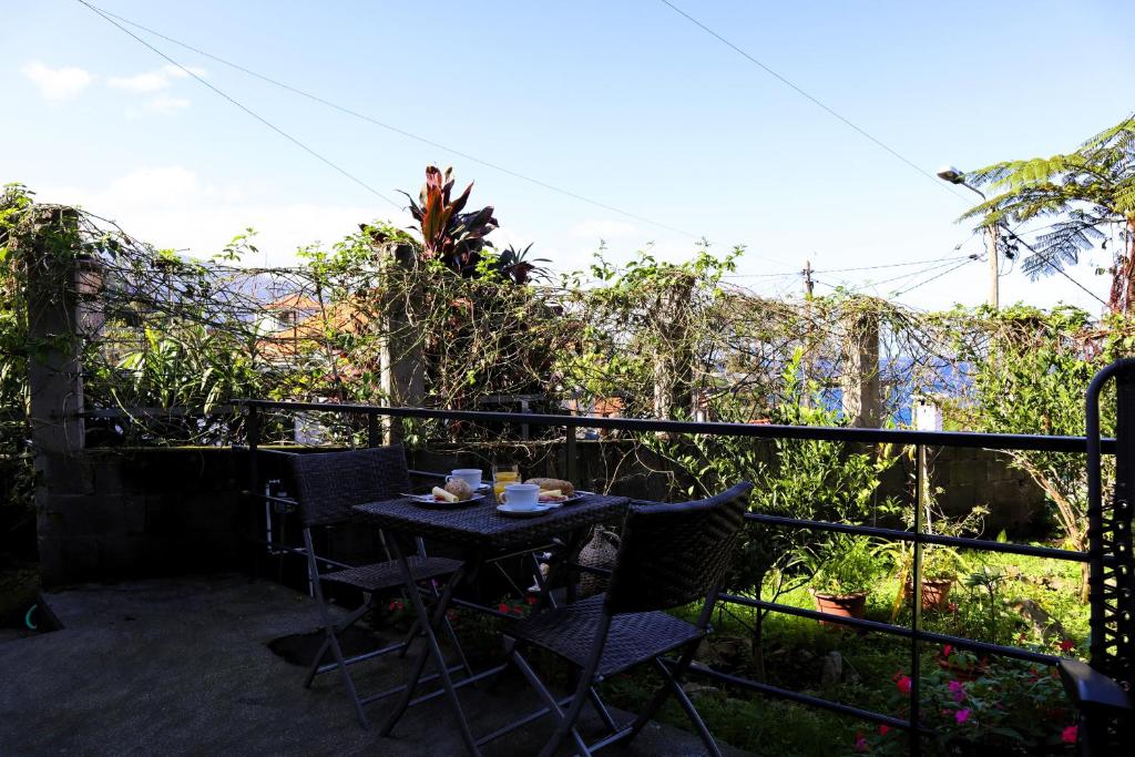 a patio with a table and chairs on a balcony at Casa do Tio Albino II, By OP in Ponta Delgada