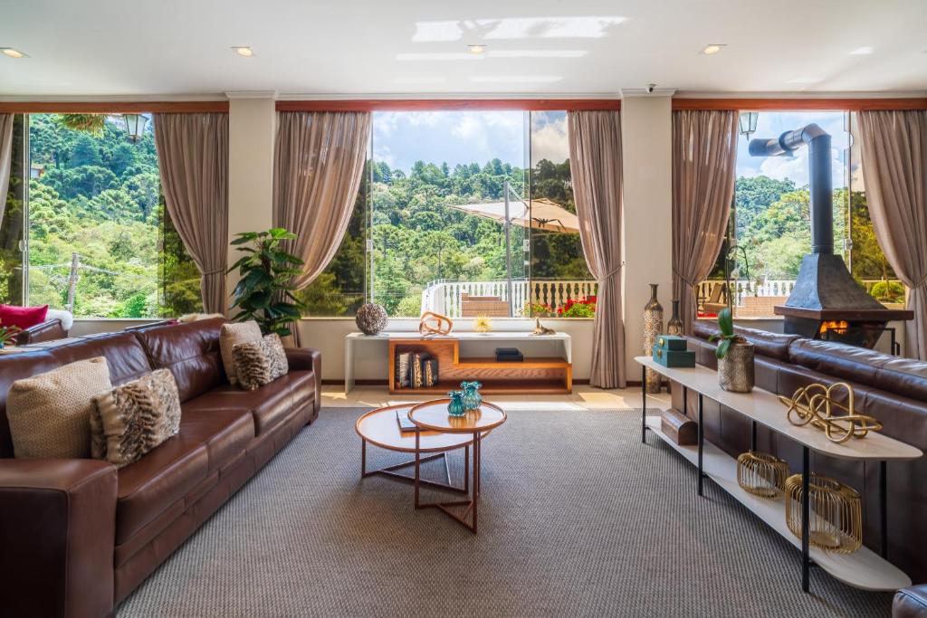 a living room with a couch and a table at Pousada Grandchamp - Campos do Jordao in Campos do Jordão