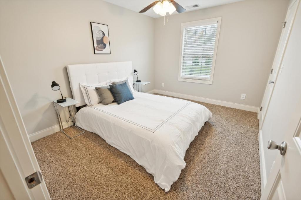 a bedroom with a white bed and a window at Biltmore Luxury 1513 #3 Townhomes L 2bd 2 Bth in Clarksville