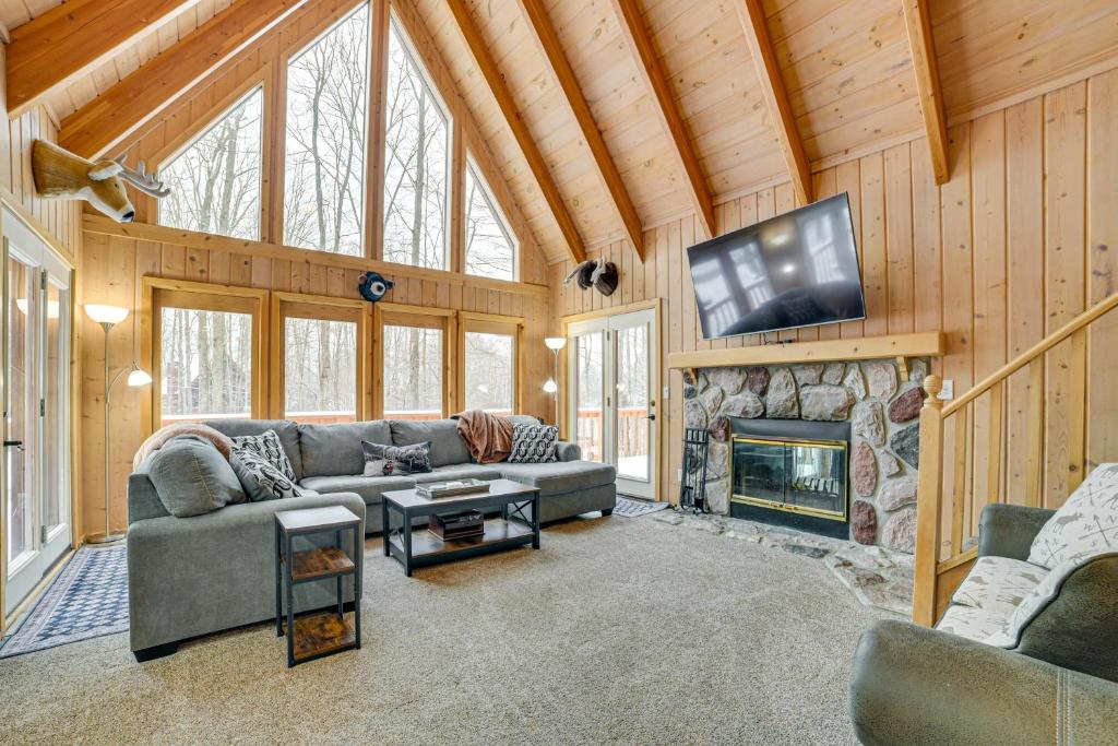 a living room with a couch and a fireplace at Less Than 1 Mi to Nubs Nob Ski Cabin with Sauna and Deck! in Harbor Springs