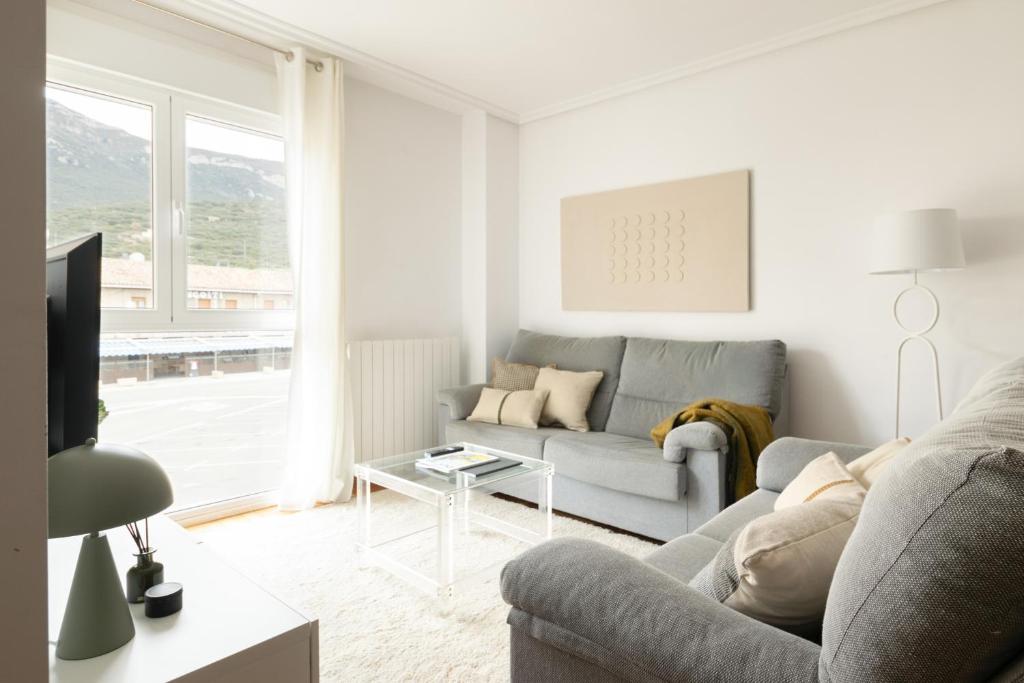 a living room with a couch and a table at Yesa by Clabao in Yesa