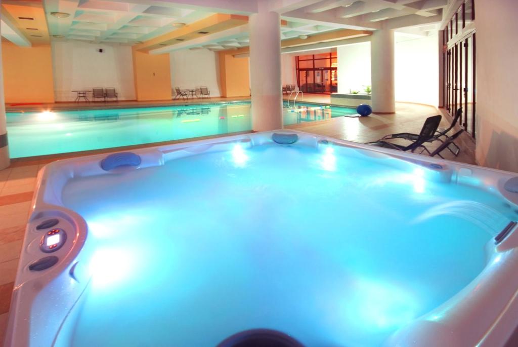 - une piscine avec bain à remous dans un bâtiment dans l'établissement Vila Teleconstructia, à Slănic-Moldova