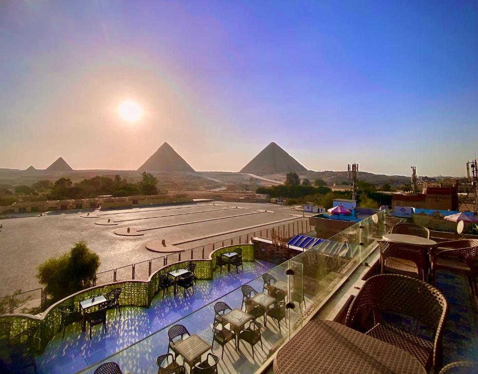 a view of the pyramids from a resort with a swimming pool at Anubis kingdom pyramids view in Cairo
