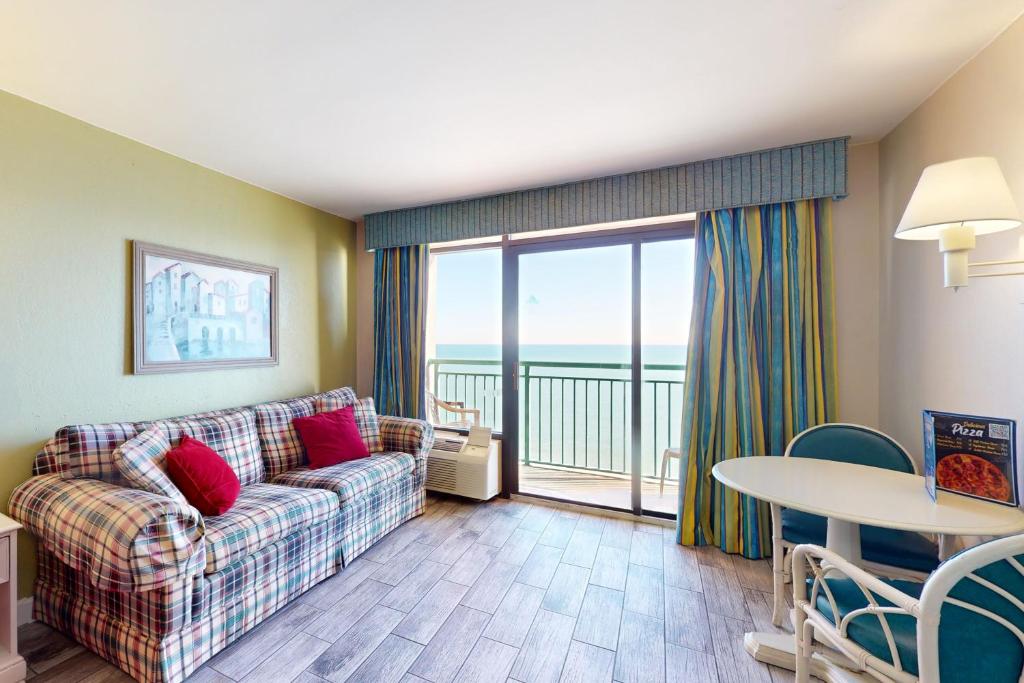 a living room with a couch and a table at Sandcastle South 1506 in Myrtle Beach