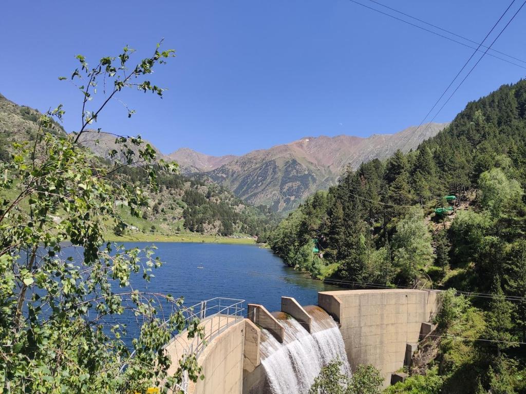 a view of a dam on a river with a waterfall at Studio idéal court séjour in Porté-Puymorens