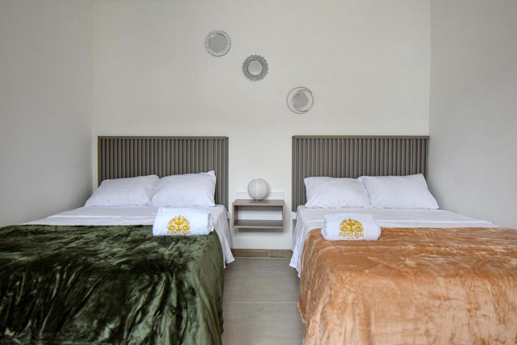 Postel nebo postele na pokoji v ubytování Hotel Fuente Real Popayán