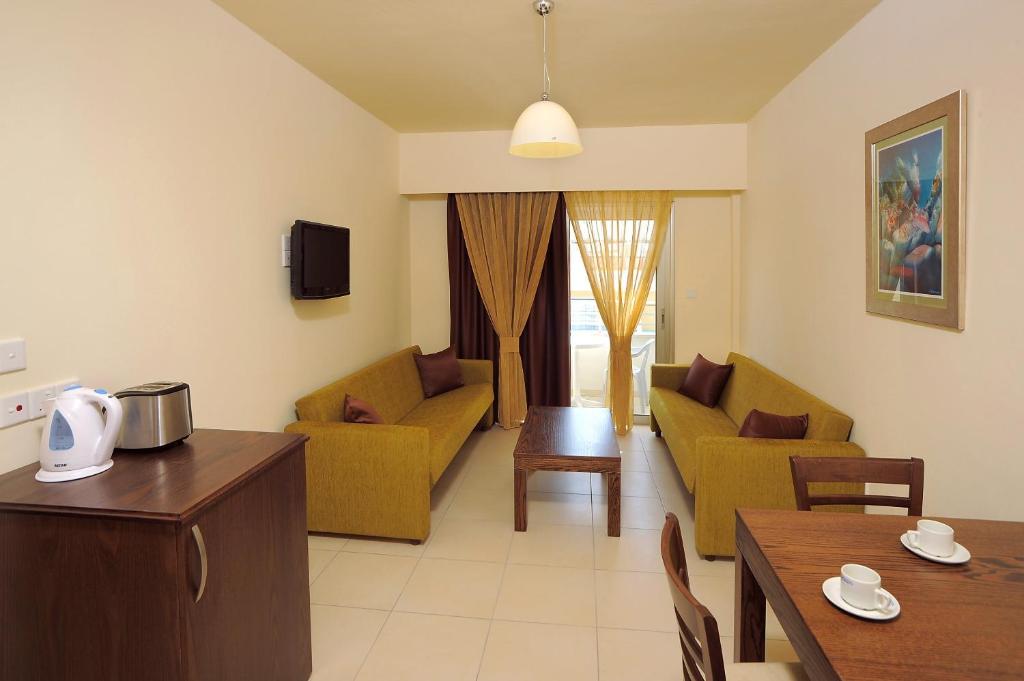 a living room with a couch and a table at Euronapa Hotel Apartments in Ayia Napa