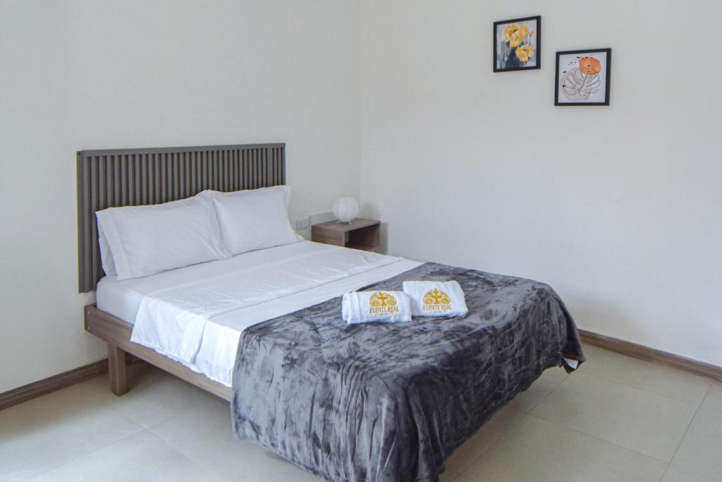 Postel nebo postele na pokoji v ubytování Hotel Fuente Real Popayán