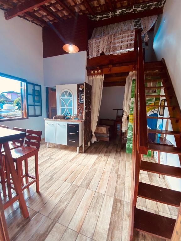 a living room with a bunk bed and a table at Íkaia Surf House in Ubatuba