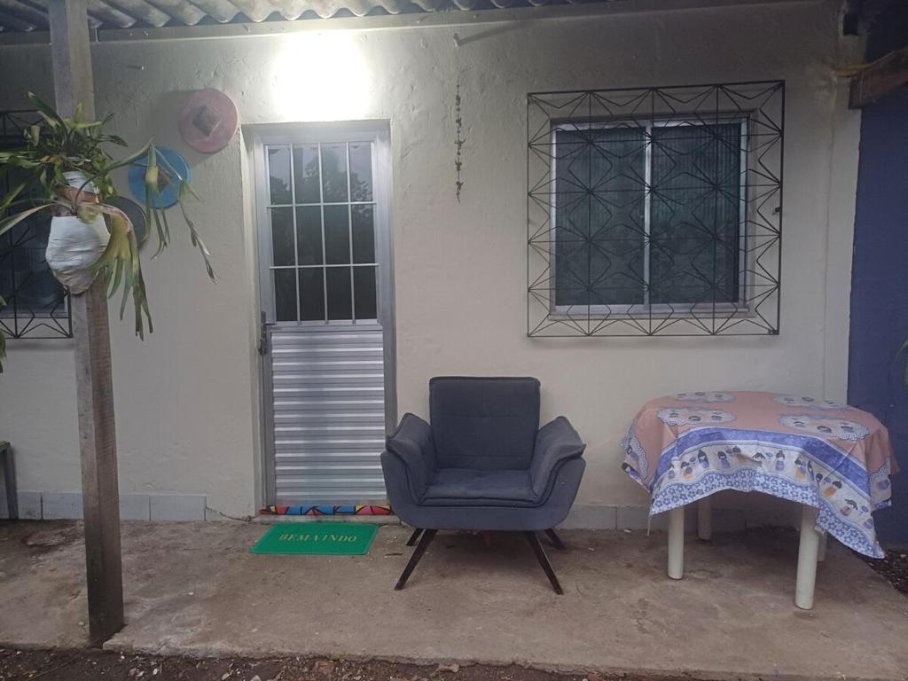 a room with a chair and a bed and a window at Residência Dazzi in Rio de Janeiro