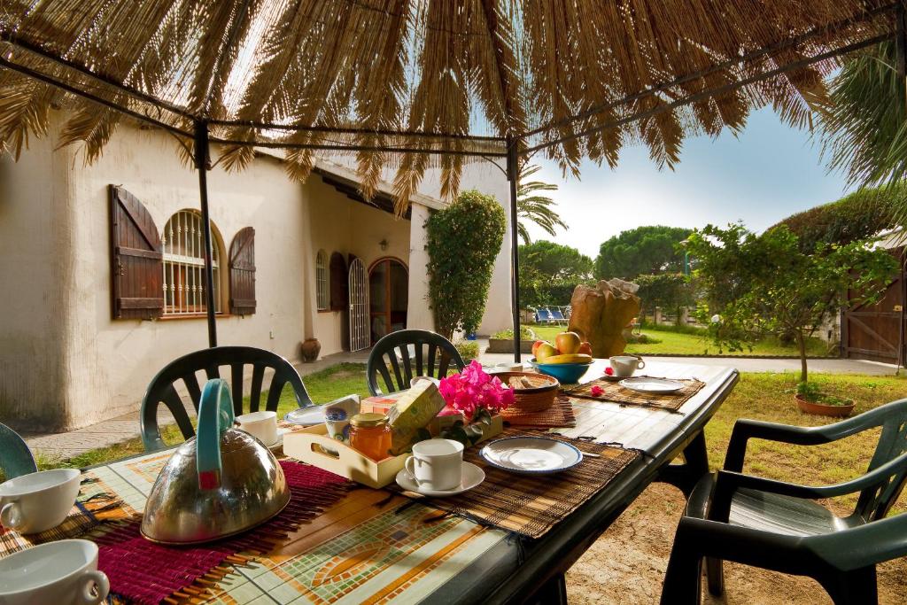 an outdoor table with a table set for a meal at Casa Stella Di Madel in Flumini di Quartu